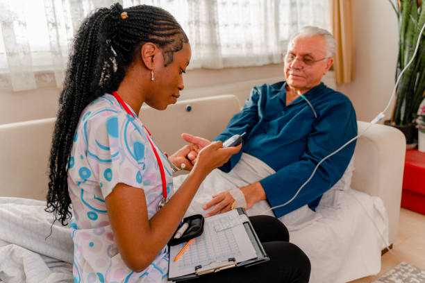 Nurse tests her senior adult patient's high blood sugar with a glucometer Nurse tests her senior adult patient's high blood sugar with a glucometer oxygen monitor stock pictures, royalty-free photos & images