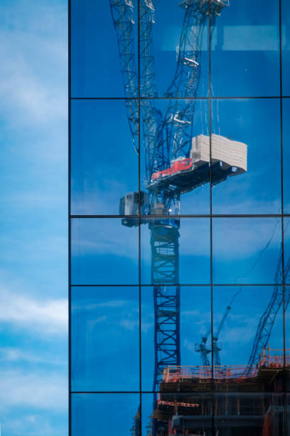 istock Tall crane reflected in mirrored windows of skyscraper in Charlotte, North Carolina. 1458853111