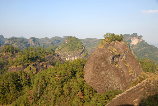 Wuyishan mountains in Fujian Province, China. Scenic view over the peaks of Wuyi mountains. A classic view of the hills from Roaring Tiger Rock.