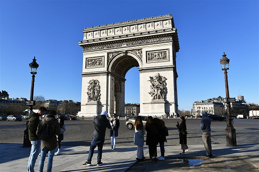 Paris, France-01 18 2023: Group of people in front of the Arc de Triomphe in Paris, France.