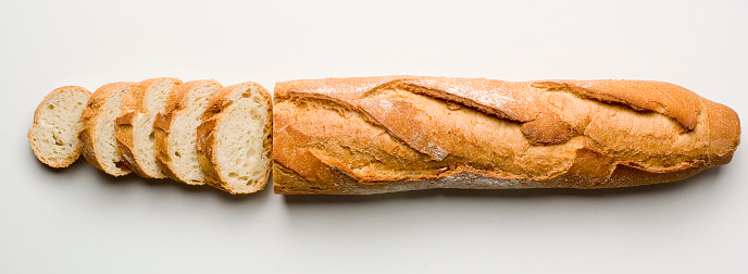 Sliced Italian bread on white background.