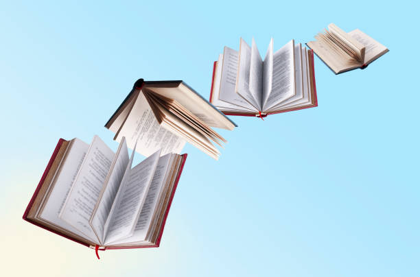 istock hardcover books fly on yellow and blue background 1458859435