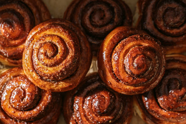 istock Freshly baked homemade Cinnamon rolls or Cinnamon buns on baking paper 1458859509