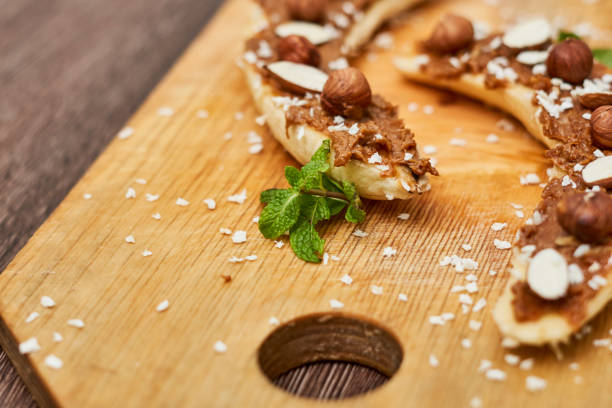 istock Bananas with peanut butter, almonds and nuts, Healthy snack 1458861653