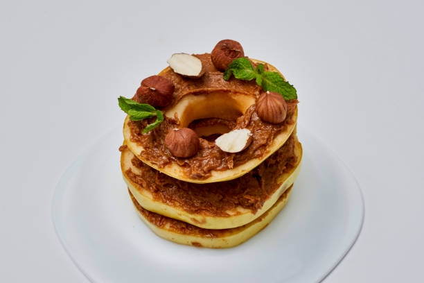istock Apple rounds dialed on top of each other with peanut butter, almonds and nuts 1458862123