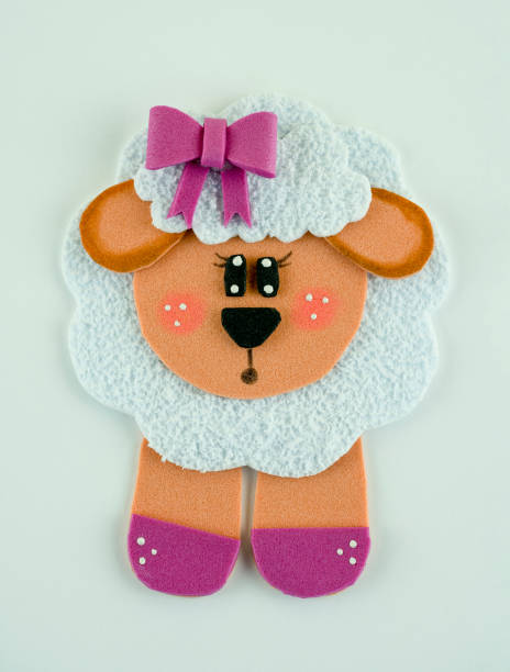 In a cozy hotel room, a soft plush sheep rests serenely on a crisp white bedsheet, embodying comfort and charm. The room exudes a tranquil atmosphere, perfect for relaxation after a day of travel or exploration. The plush toy, with its fluffy wool and gentle demeanor, adds a touch of whimsy and warmth to the neatly arranged bedding. Set against a backdrop of muted décor and soft lighting, the scene invites a sense of peaceful retreat, where the plush sheep becomes a delightful companion in this serene setting.