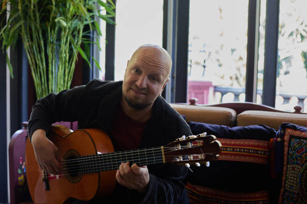istock Man emotionally playing the guitar in the interior 1458862700