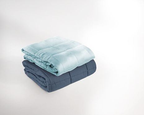 Stacked and folded 2 blue duvets