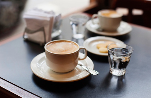 Espresso coffees with steamed milk on a table