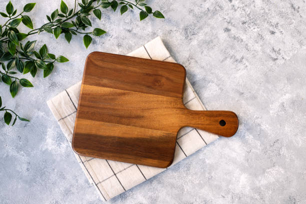 istock Cutting board over marble table background. Cooking backdrop. Top view with space for your recipe 1458865608