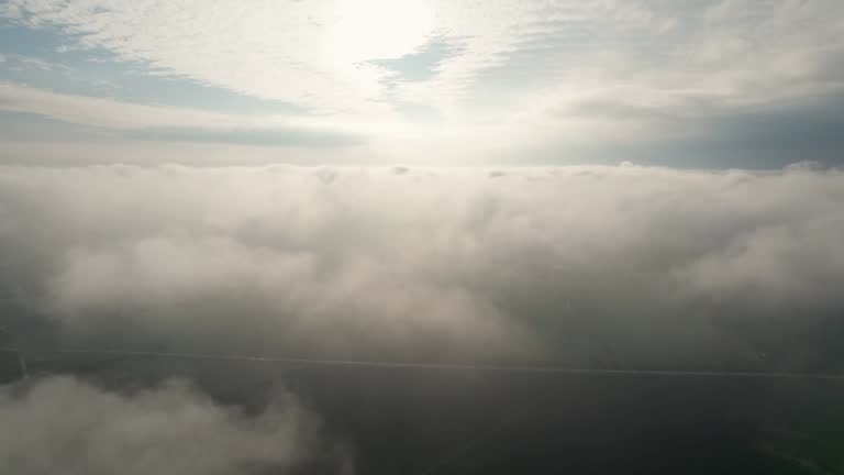 Flight in the clouds above the city. Camera view of flying into clouds. Into the clouds. Vertical camera movement. Version 4.