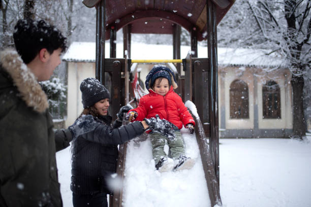 istock brothers having fun in the snow in the park 1458868784