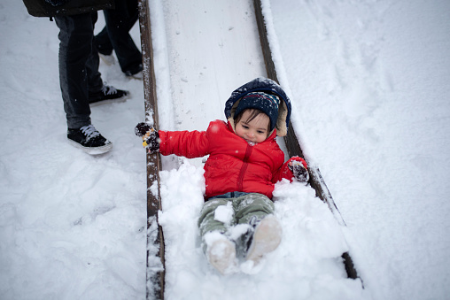 Child having fun on snow tube. Boy is riding a tubing. Winter fun for children.