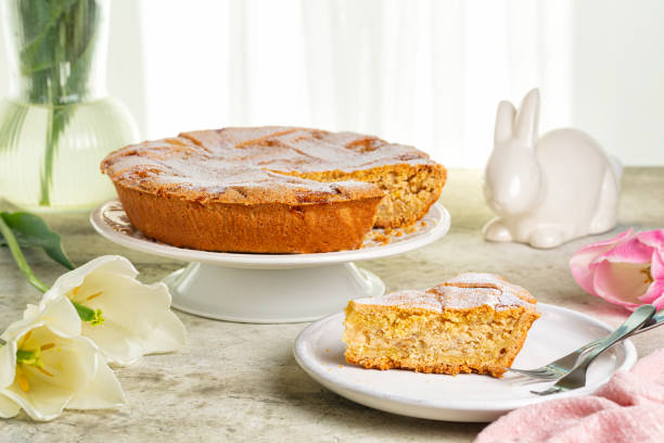 Italian Easter cake. Pastiera Napoletana. Traditionally made with  pre-cooked wheat grains, grano cotto, ricotta cheese and orange flower water. Easter table. stock photo