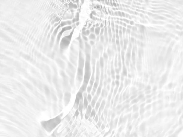 istock Defocus blurred transparent white colored clear calm water surface texture with splashes and bubbles. Trendy abstract nature background. Water waves in sunlight with copy space. White water shine 1458885803