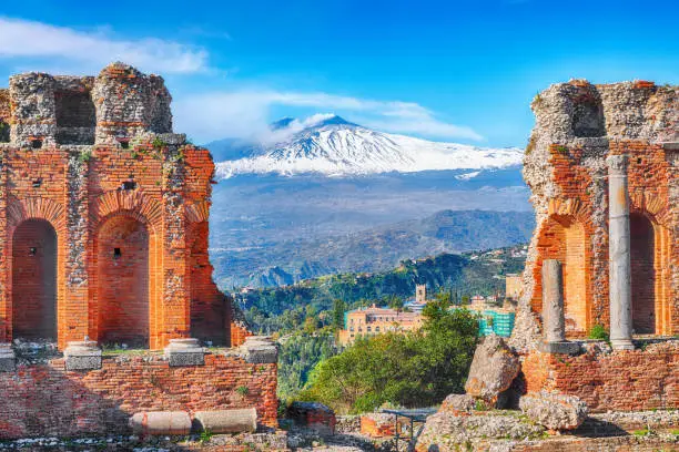 Photo of Ruins of ancient Greek theater in Taormina and Etna volcano in the backgroun