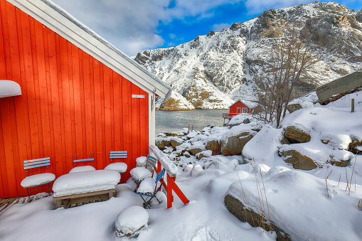 Awesome morning seascape of Norwegian sea and cityscape of Nusfjord village. Popular travel destination on Lofotens. Location: Nusfjord, Flakstad Municipality, Lofoten; Norway, Europe