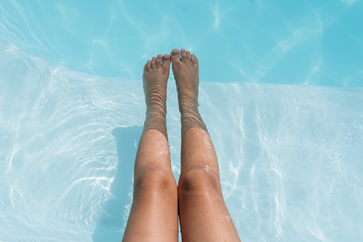 Relaxed legs in the pool