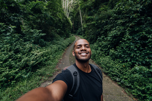 Backpacker taking a selfie on the forest trail