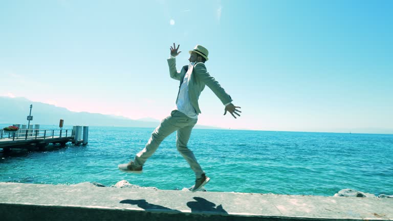 Carefree Young Man Jumping Joyful Outside In Summer Time