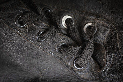 Extreme close-up of the shoelaces on a pair of vintage baseball cleats.