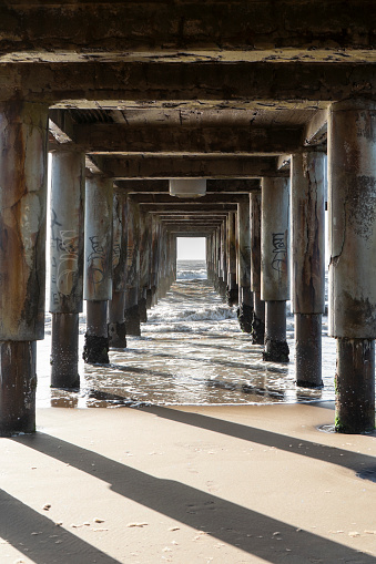 A vertical shot under a pier in Pinamar Beach, Argentina in Pinamar, Buenos Aires Province, Argentina