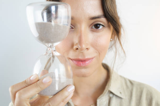 istock Young Woman Aging Holding Hourglass 1458901658
