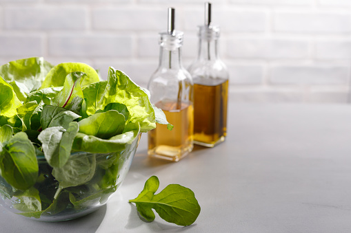 Different types of salad leaves with oil and vinegar