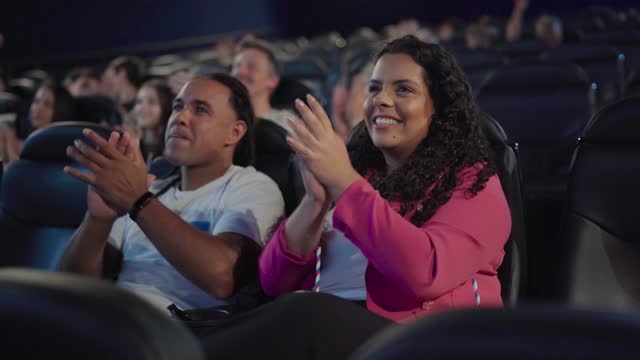 Couple applauding at the cinema