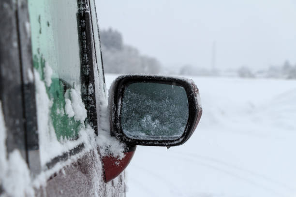 istock driving a car on a snowy road in winter 1458914436