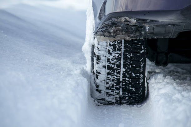 istock driving a car on a snowy road in winter 1458914471