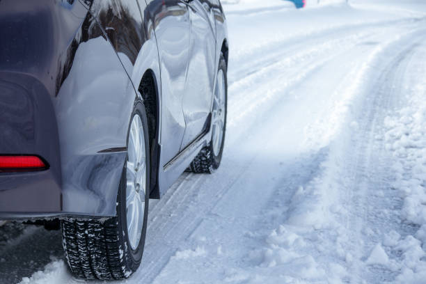 istock driving a car on a snowy road in winter 1458914512