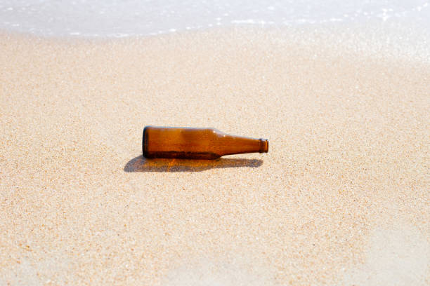 istock Glass bottle on the beach 1458916431