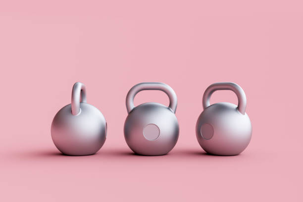 istock Silver metal kettlebell isolated on pink background 1458918691