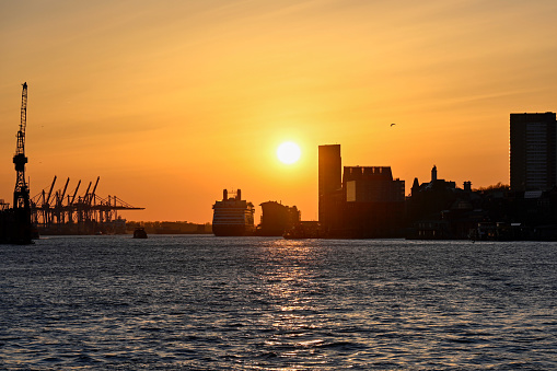 Hamburg, Germany, March 19, 2022 - Hamburg Industrial Harbor at sunset, seen from St. Pauli Landungsbrücken.