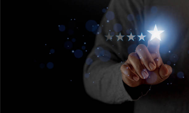istock Satisfaction close up on customer man hand pressing on screen with five star rating feedback icon and press level excellent rank for giving best score point to review the service concept 1458944354
