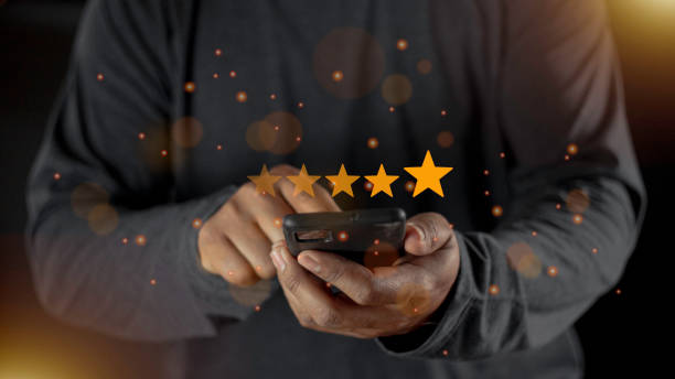 istock Satisfaction close up on customer man hand pressing on screen with five star rating feedback icon and press level excellent rank for giving best score point to review the service concept 1458944392
