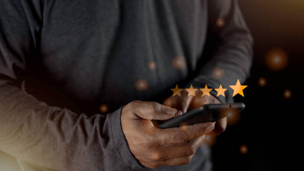 istock Satisfaction close up on customer man hand pressing on screen with five star rating feedback icon and press level excellent rank for giving best score point to review the service concept 1458944394
