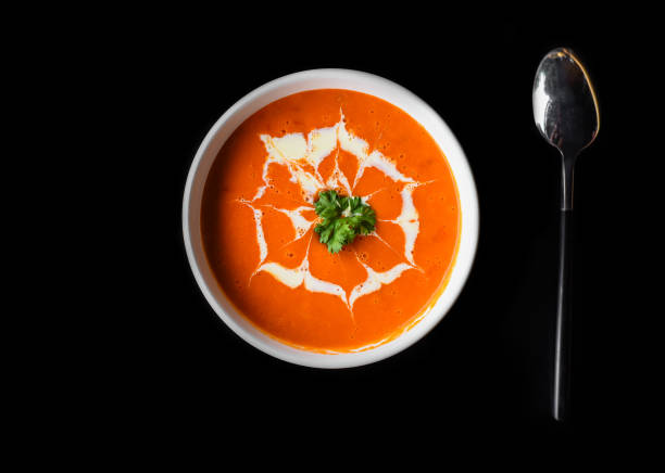 istock Tomato cream soup on black background 1458948794