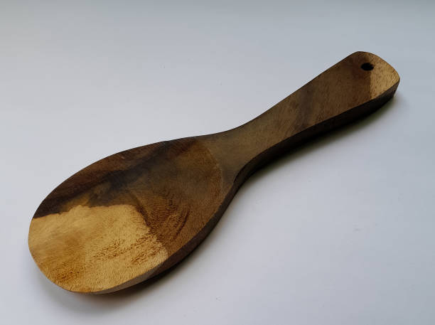istock Rice scoop made of wood on a white background 1458968410