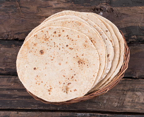 Indian Traditional Cuisine Chapati Also Know as Roti, Fulka, Paratha, Indian Bread, Flatbread, Whole Wheat Flat Bread, Chapathi, Wheaten Flat Bread, Chapatti, Chappathi or Kulcha on Wooden Background