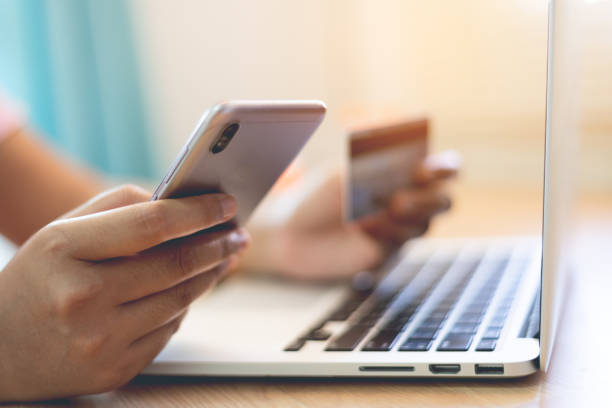 istock Woman using credit card to pay online 1458976602