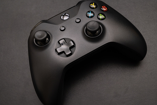 Wireless gamepad for the Xbox One on desk. Black Xbox game controller.
