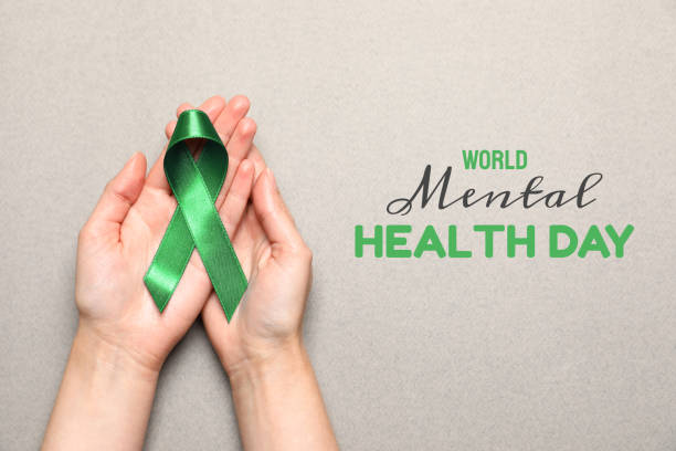 dia mundial da saúde mental. mulher que segura a fita verde no fundo cinzento claro, vista superior - cancer victim - fotografias e filmes do acervo