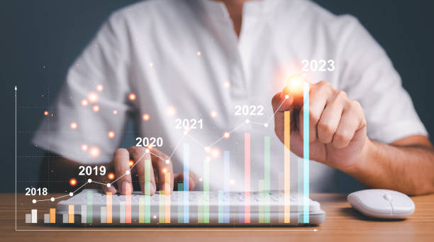 istock Businessman hand holding  virtual increasing technical graph and up arrow for trader analysis to searching the best business growth and profit return from stock market chart concept. 1458984748