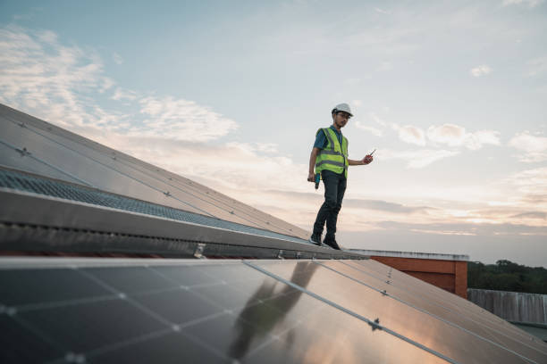 istock Service engineer checking solar cell on the roof for maintenance if there is a damaged part. Engineer worker install solar panel. Clean energy concept. 1458990218