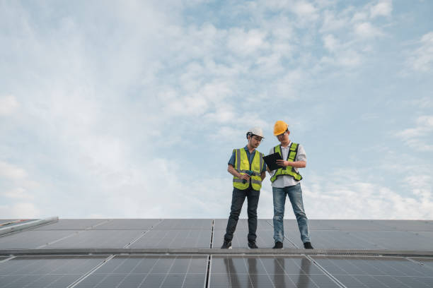 istock Service engineer checking solar cell on the roof for maintenance if there is a damaged part. Engineer worker install solar panel. Clean energy concept. 1458990848