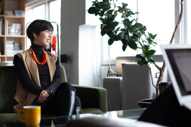 istock Young businesswoman chatting with colleagues in a creative office. 1458993373