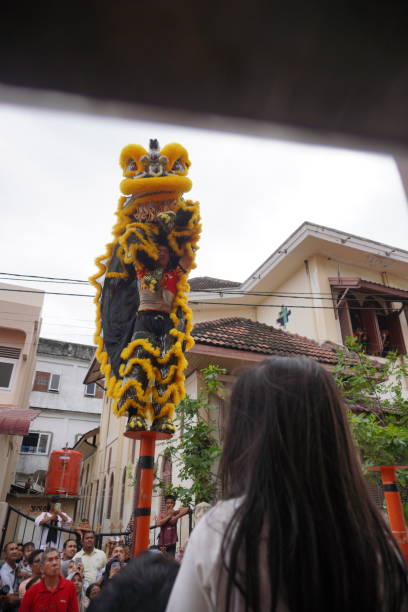 Banda Aceh, Indonesia - January 22, 2023 ;  hundreds of people enthusiastically watched the lion dance performance held around the monastery to celebrate Chinese New Year 2023
