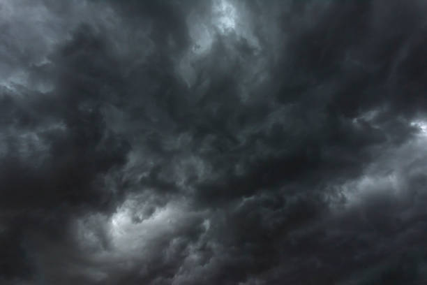 istock Dramatic dark storm rain clouds black sky background. Dark thunderstorm clouds rainny atmosphere. Meteorology danger windstorm disasters climate. Dark cloudscape storm disaster gloomy gray cloud sky 1458995378